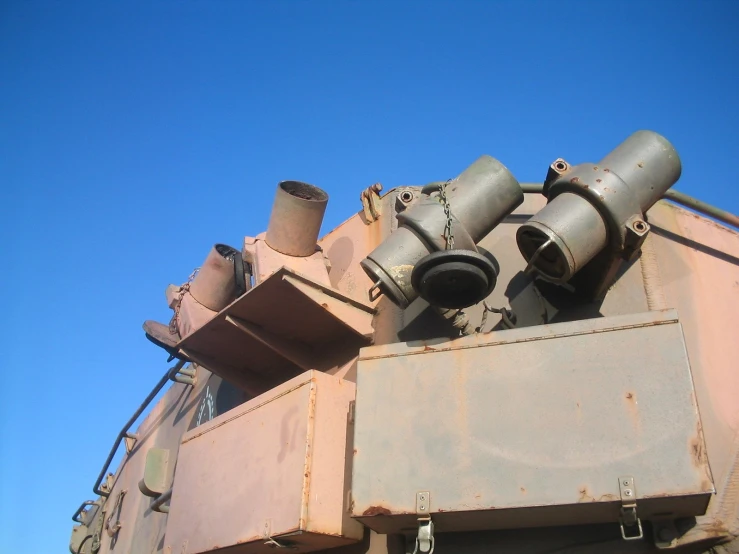 a po of an army tank in front of a clear sky