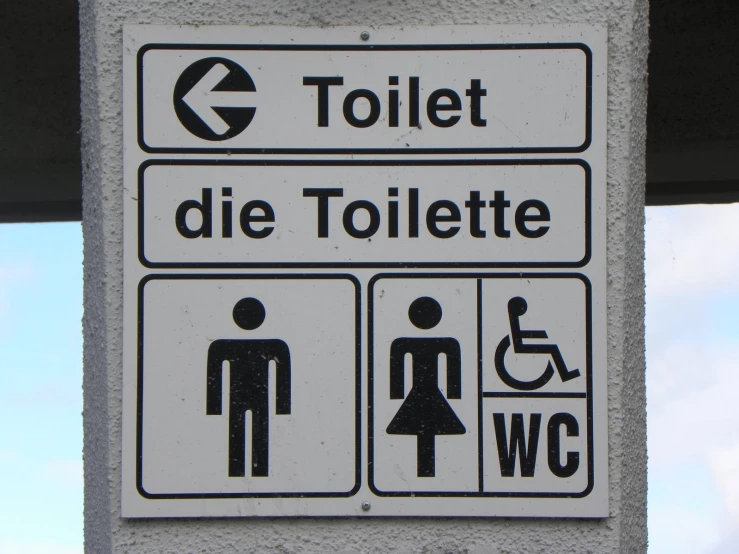 a street sign that reads toliet and toilet