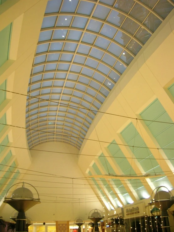 the ceiling in this indoor building has blue glass shades on it