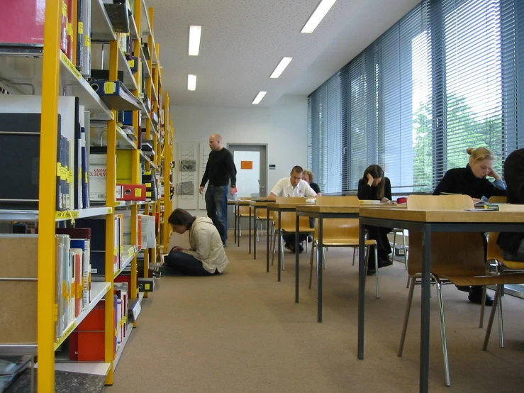 students and parents sitting down in the liry