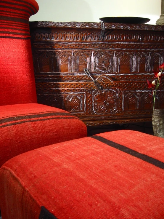 a large wooden cabinet and a chair in a room