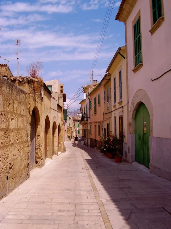 a narrow cobblestone street in a town setting