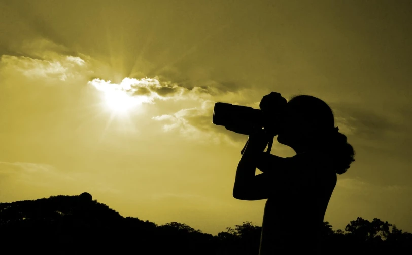 the silhouette of a pographer with their camera