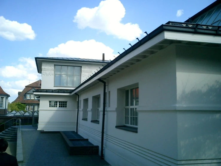 the back side of a home with a black and white bench