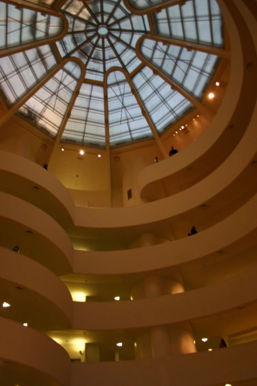 a circular lobby with an interesting ceiling and glass window