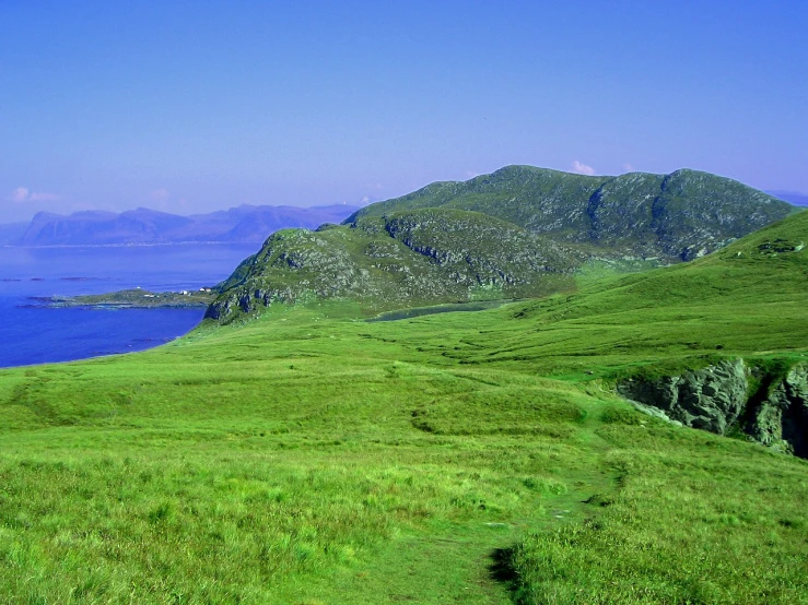 a field with a large body of water next to it