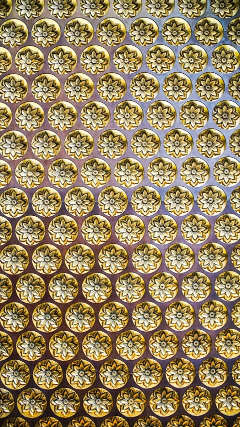 golden circles are arranged over an abstract pattern