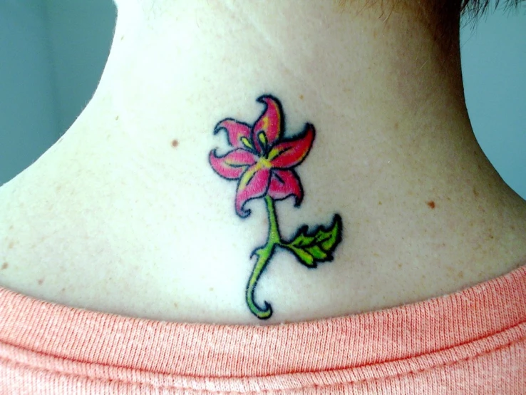 a beautiful tattoo design with pink flowers on the neck