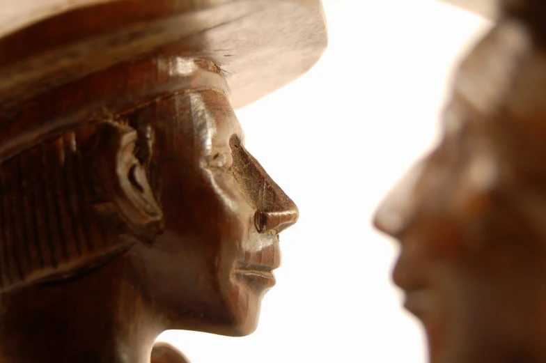 the head and shoulders of a wooden statue