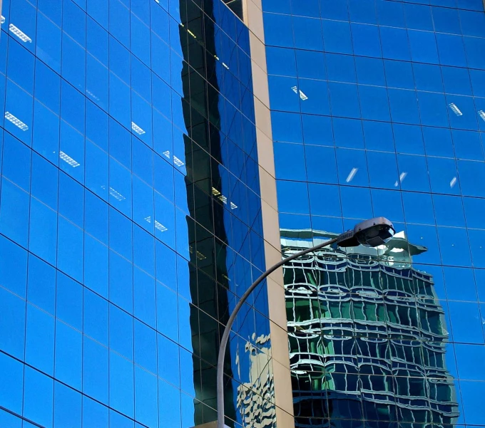 a building with glass windows next to another building