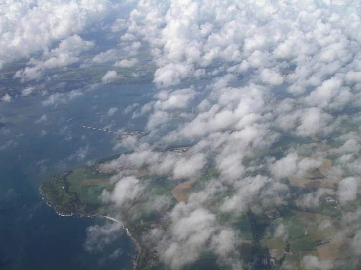 a field and ocean view is seen from the air