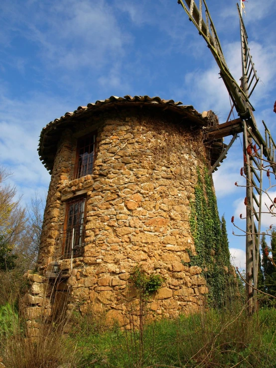 the old wind mill is in the middle of nowhere