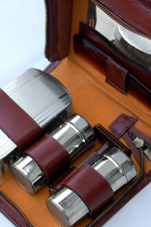 a set of four leather lighters on a case