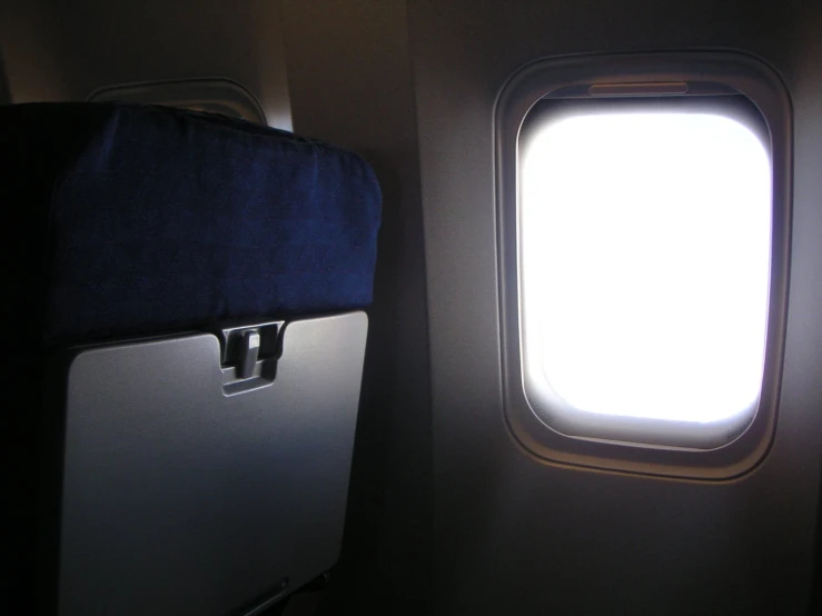 an airplane window with the seat facing up