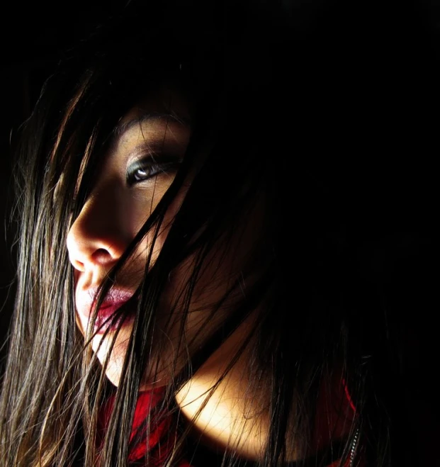 a young woman with dark hair and makeup