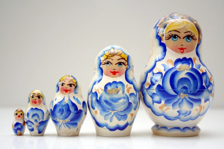 a collection of russian dolls with blue flowers