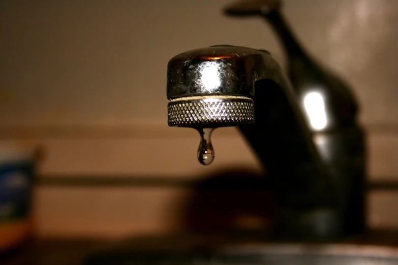 a faucet with some liquid flowing out