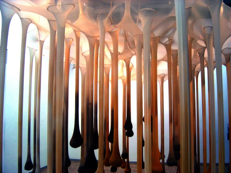 a group of wooden spoons stuck to a tall wall