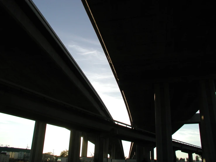 an underpass near some water and clouds