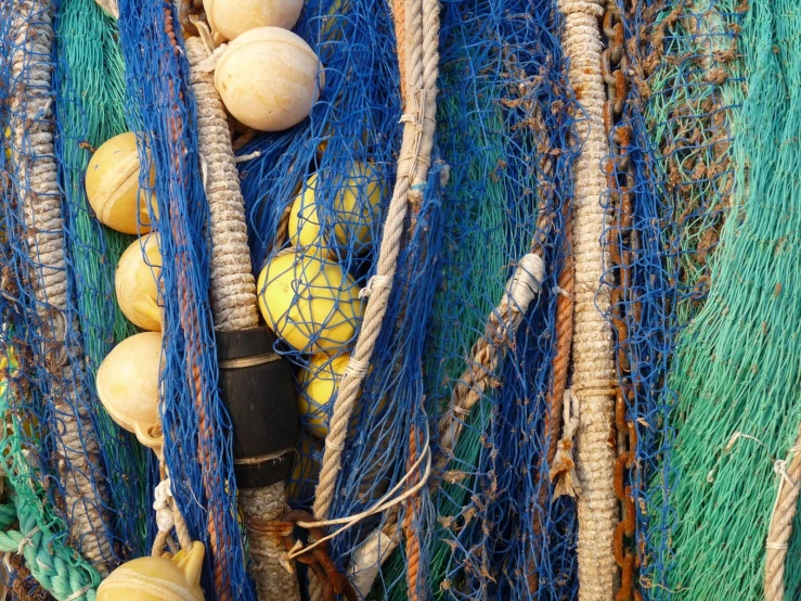 several blue and white nets, two of which have small yellow balls and gourds in them