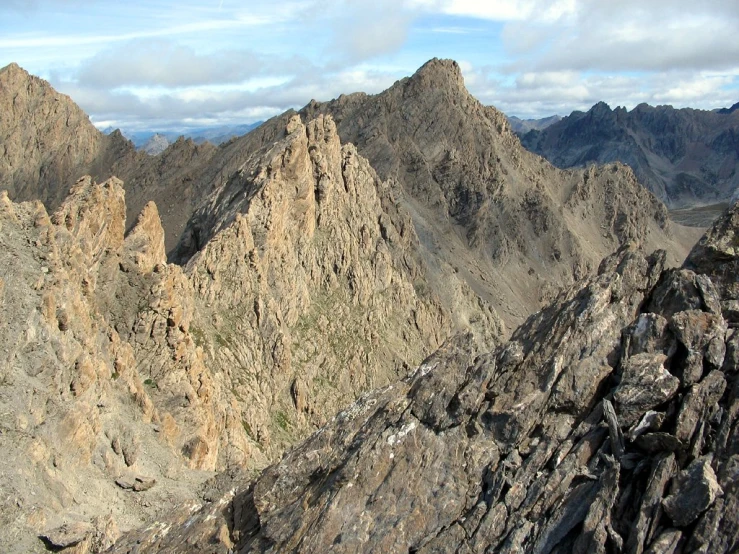 a po of a rocky mountain range with some rocks and a few trees