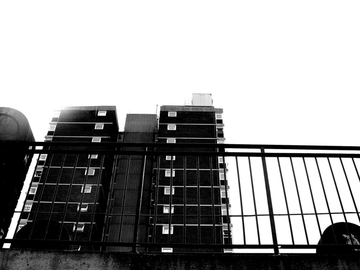 a high rise building with balconies and black and white pograph