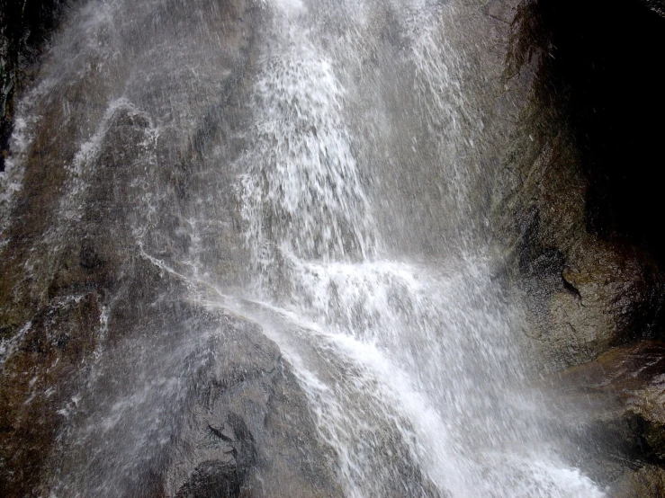 the water is crashing over some rocks