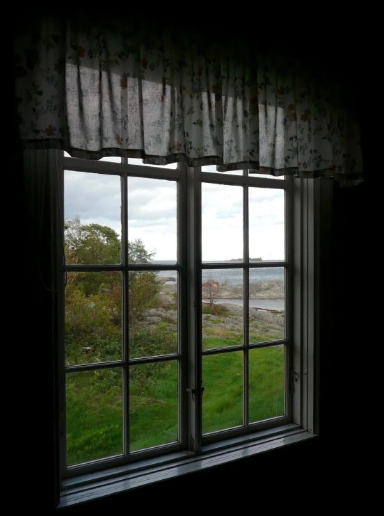 a house with an open window, view of a green yard