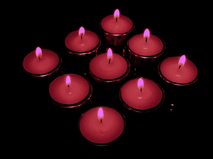 a group of lit candles sitting next to each other
