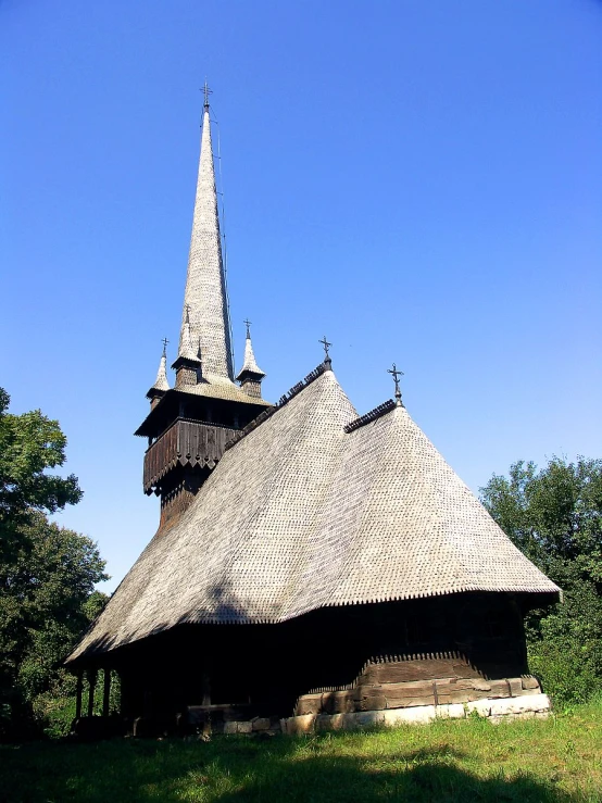 an old wooden building with a steeple and a clock