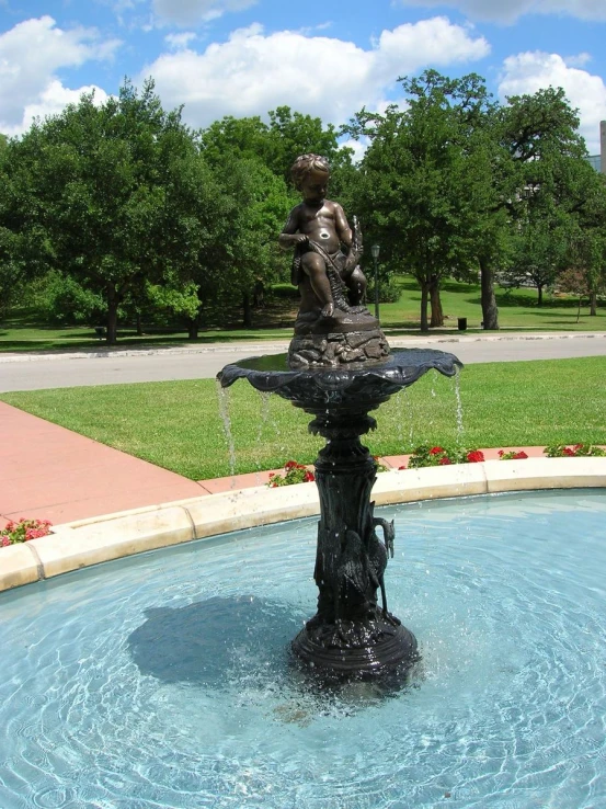 a beautiful fountain on the side of a street