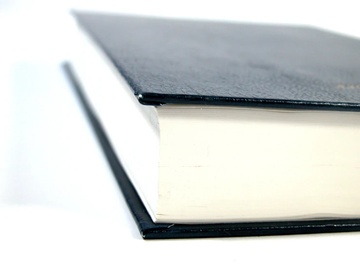 a black book opened on top of white paper