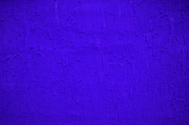 an old dark blue paint textured on a wall