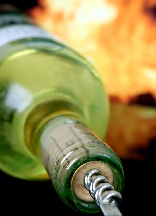 the top of a green bottle, with a cork resting in the end