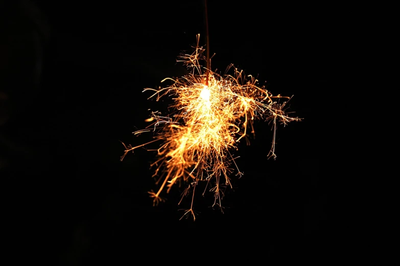 firework is seen in the dark, bright yellow