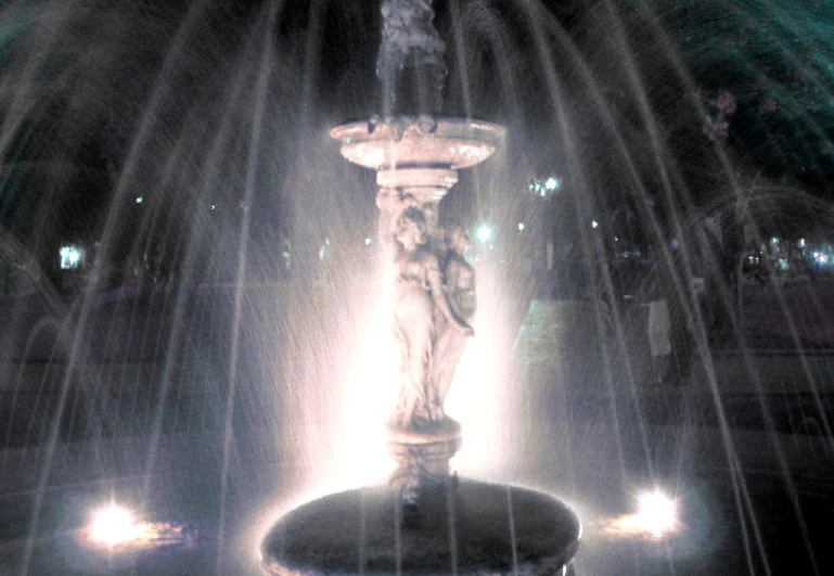 the fountain is illuminated by the bright lights