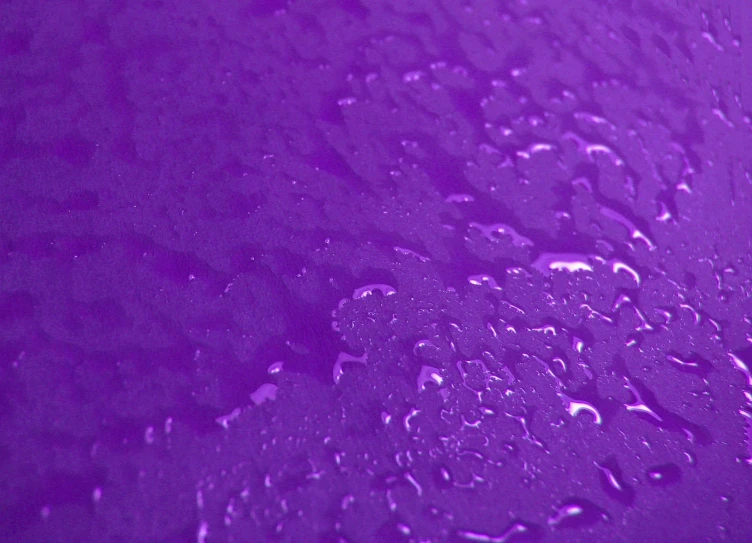 a picture of purple and black water drops