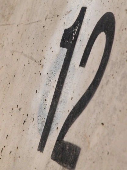 the number twenty - seven is etched into a cement surface