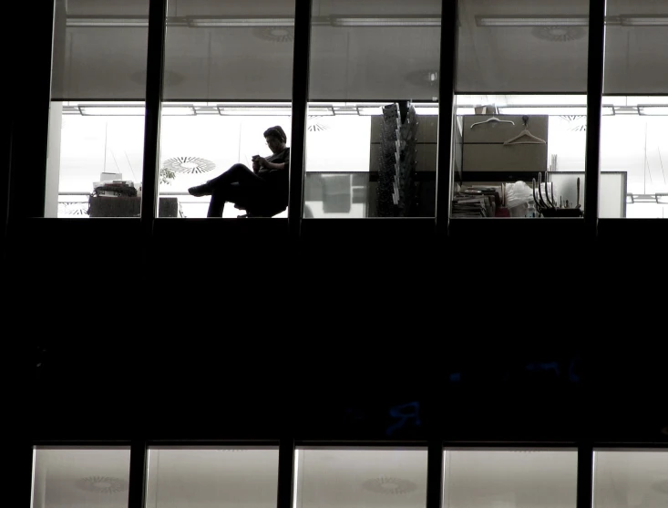 a man sitting on the balcony of his apartment alone