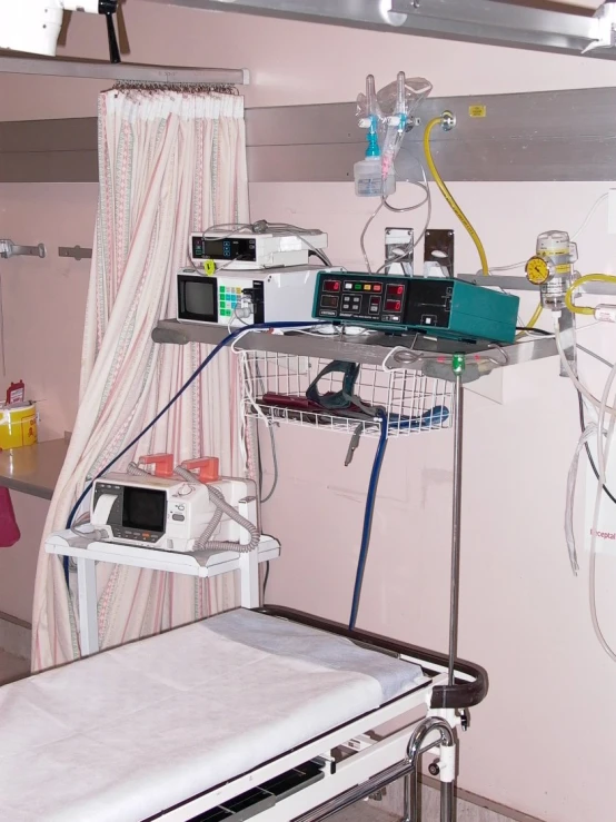 a hospital room filled with machines, machines and other equipment