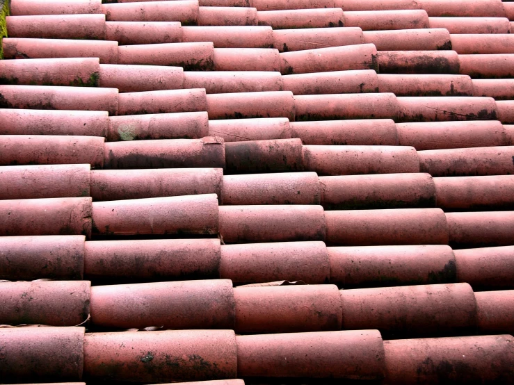 several long brick chimneys sit on top of the roof