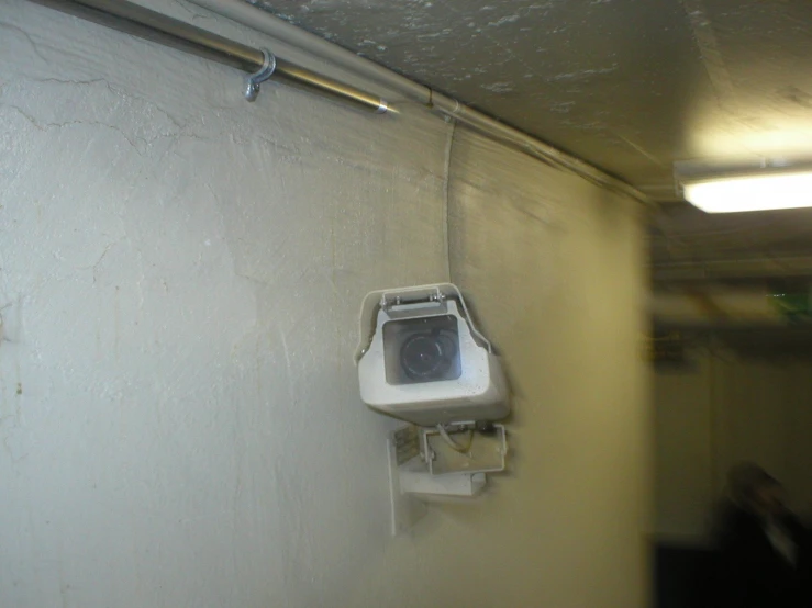 a security camera sitting on the side of a wall