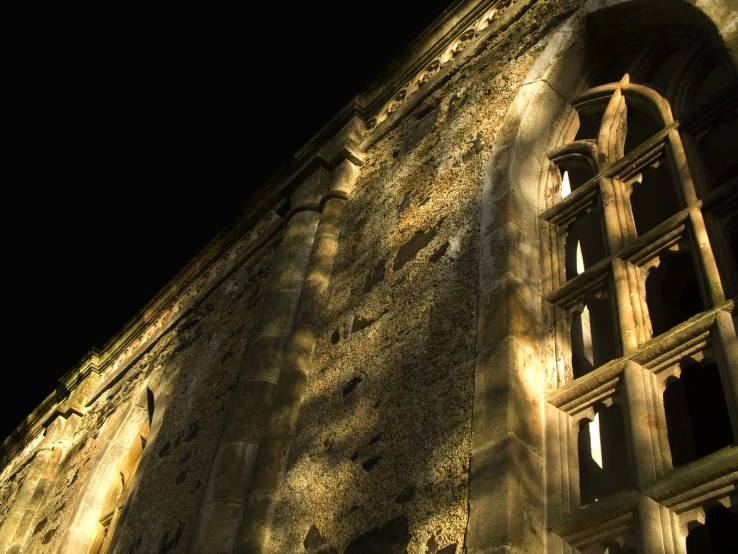 a large stone building with a clock displayed on it's side