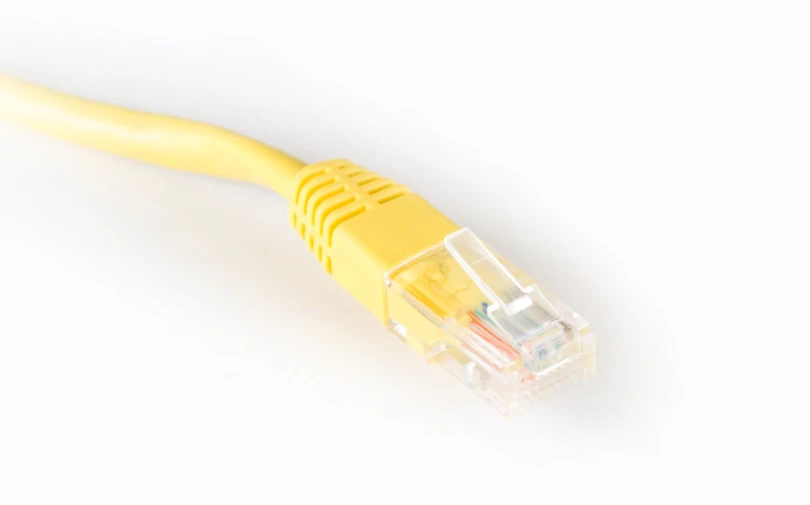 a yellow cat 5e cable on a white background