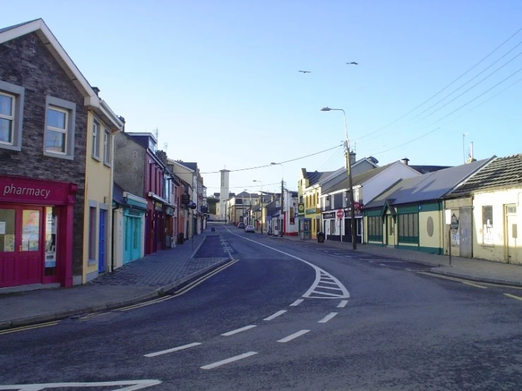 a deserted street with shops in the foreground