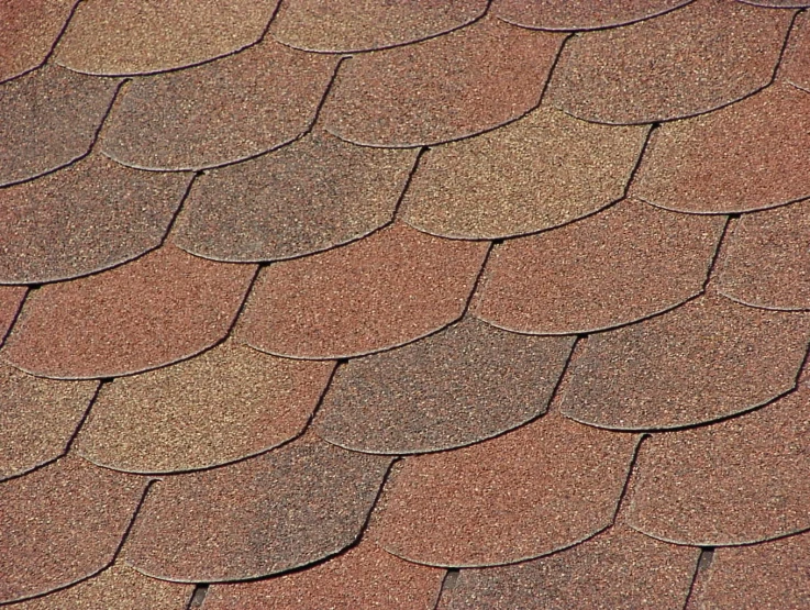 a roof covered in brown shingles and white trim