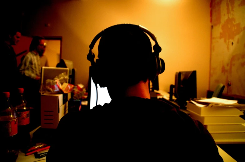 a man with headphones on working at a computer