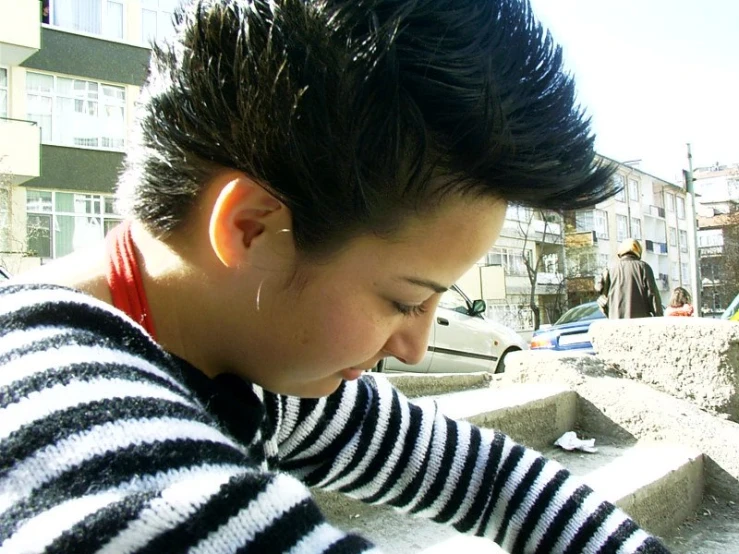  with mohawk combing hair and ear piercings