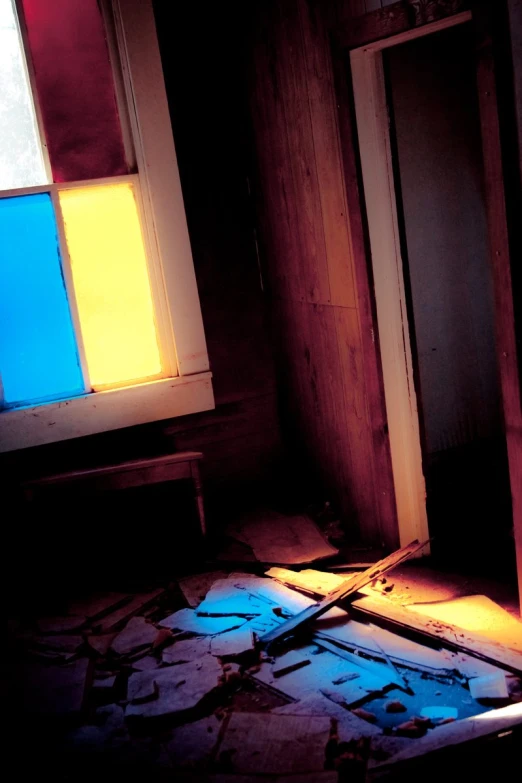 an open door in an abandoned room with light coming through