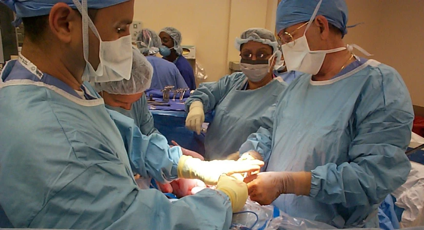 a group of surgeons performing  on a patient